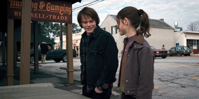 Wide shot frame from Stranger Things — standing, dialogue, coat