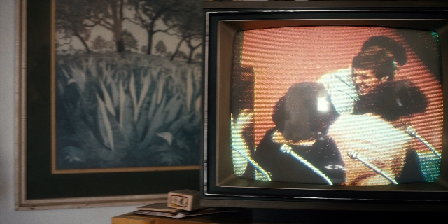 Wide shot frame from Stranger Things — dialogue, shirt, television