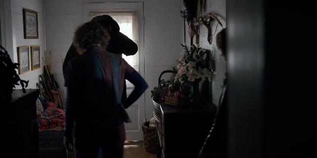 Wide shot frame from Stranger Things — standing, room, door