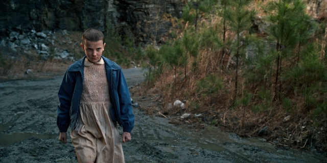 Wide shot frame from Stranger Things — walking, night, dress
