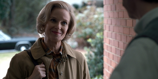 Medium shot frame from Stranger Things — standing, dialogue, street