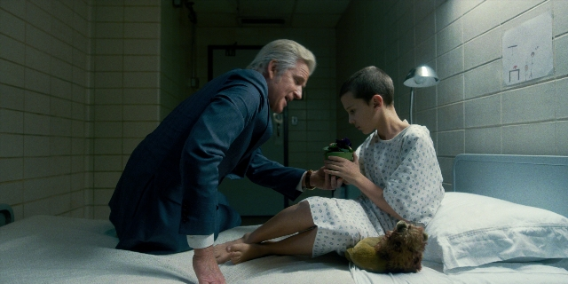 Wide shot frame from Stranger Things — sitting, room, bed