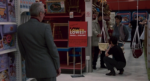Wide shot frame from The Color of Money — standing, suit, face
