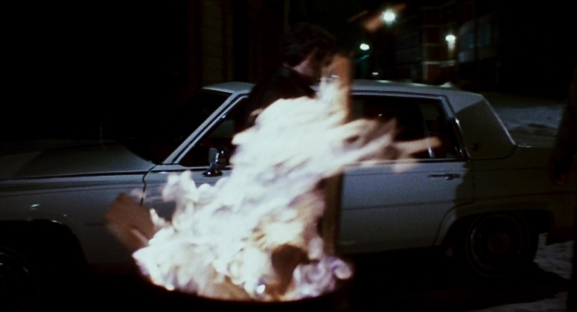 Wide shot frame from The Color of Money — street, fire, car