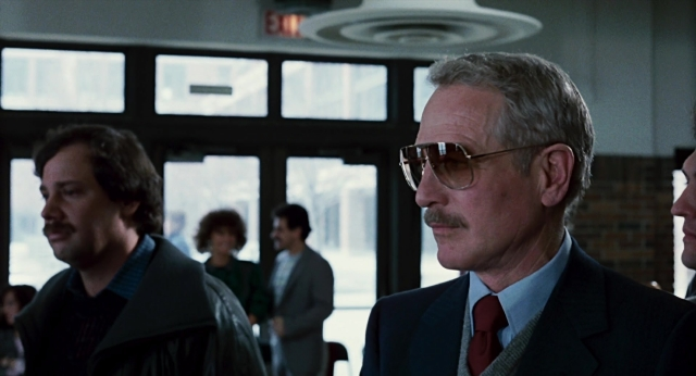 Medium shot frame from The Color of Money — standing, room, suit