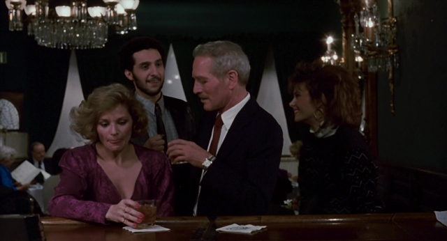 Close-up frame from The Color of Money — sitting, room, dialogue