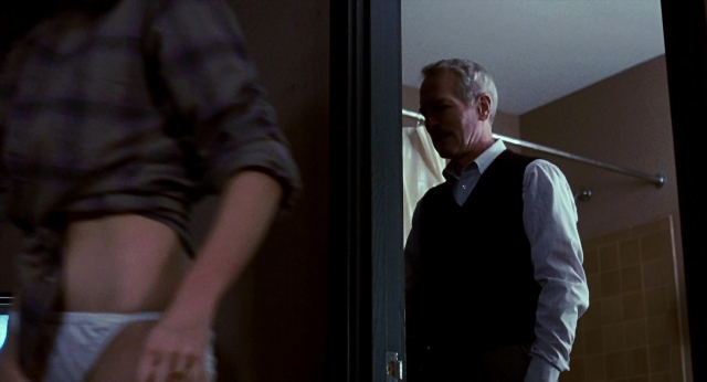 Wide shot frame from The Color of Money — standing, door, mirror