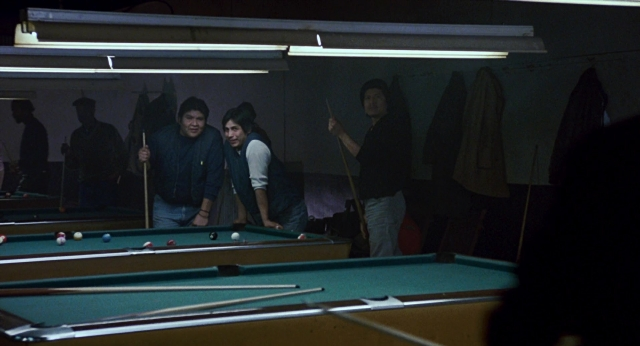 Wide shot frame from The Color of Money — standing, room, table