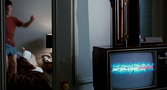 Wide shot frame from The Color of Money — standing, room, bed
