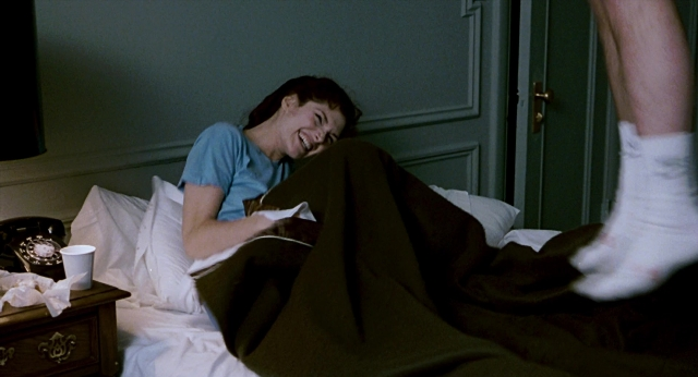 Wide shot frame from The Color of Money — room, bed, phone