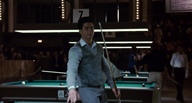 Wide shot frame from The Color of Money — standing, room, table
