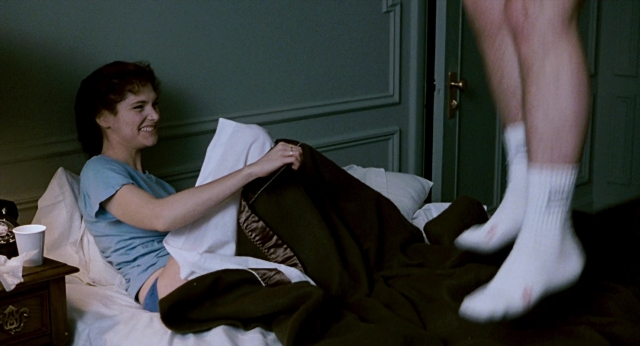 Wide shot frame from The Color of Money — sitting, bed, door
