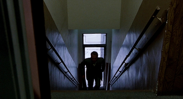 Wide shot frame from The Color of Money — standing, suit, tie