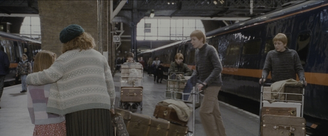 Wide shot frame from Harry Potter and the Sorcerer's Stone — standing, walking, hand