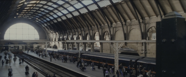 Wide shot frame from Harry Potter and the Sorcerer's Stone — sitting, walking, train