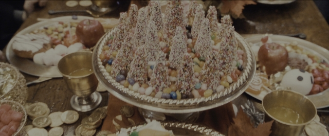 Wide shot frame from Harry Potter and the Sorcerer's Stone — room, table, bird