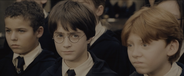 Medium shot frame from Harry Potter and the Sorcerer's Stone — suit, face, hair