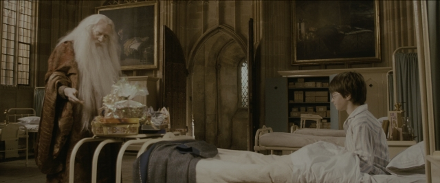Wide shot frame from Harry Potter and the Sorcerer's Stone — standing, room, table
