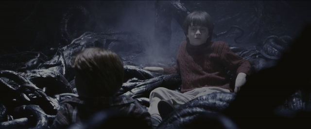 Wide shot frame from Harry Potter and the Sorcerer's Stone — sitting, bed, face
