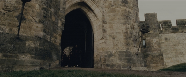Wide shot frame from Harry Potter and the Sorcerer's Stone — standing, castle, person