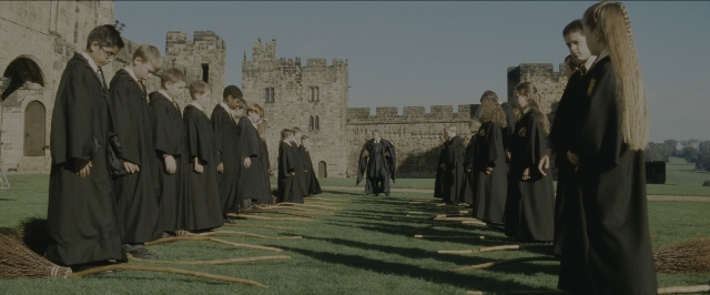 Wide shot frame from Harry Potter and the Sorcerer's Stone — standing, walking, castle