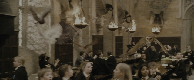 Wide shot frame from Harry Potter and the Sorcerer's Stone — sitting, room, face