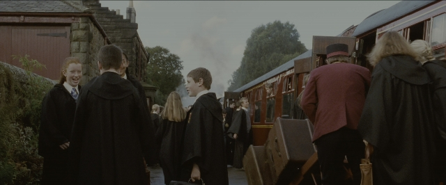 Wide shot frame from Harry Potter and the Sorcerer's Stone — standing, dialogue, train