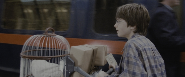 Frame from Harry Potter and the Sorcerer's Stone — sitting, hand, shirt