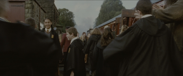 Wide shot frame from Harry Potter and the Sorcerer's Stone — standing, train, smoke