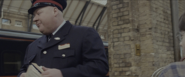 Wide shot frame from Harry Potter and the Sorcerer's Stone — book, standing, hat