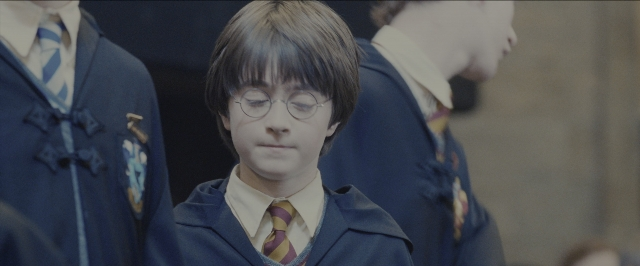 Medium shot frame from Harry Potter and the Sorcerer's Stone — standing, uniform, suit