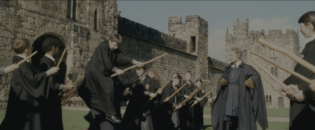 Wide shot frame from Harry Potter and the Sorcerer's Stone — standing, castle, person