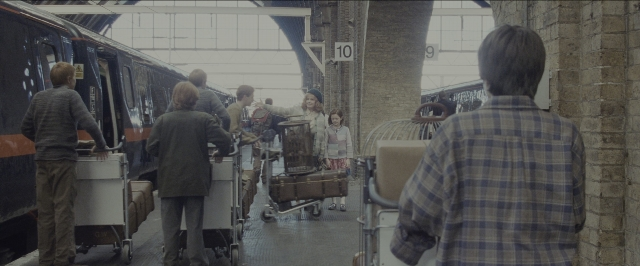 Wide shot frame from Harry Potter and the Sorcerer's Stone — standing, train, person