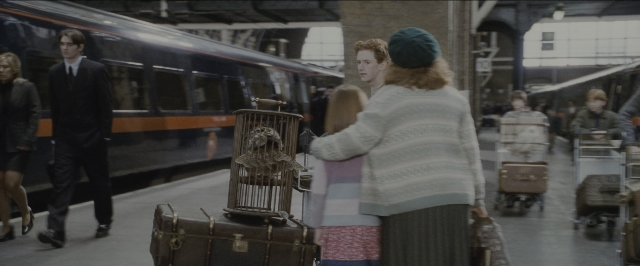 Wide shot frame from Harry Potter and the Sorcerer's Stone — standing, hand, face