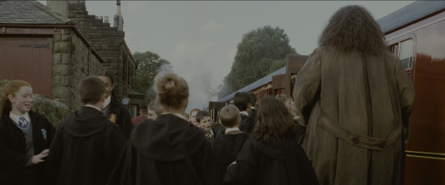 Wide shot frame from Harry Potter and the Sorcerer's Stone — standing, train, smoke
