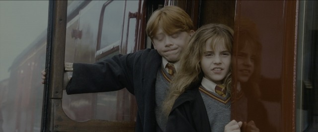 Wide shot frame from Harry Potter and the Sorcerer's Stone — standing, tie, hair