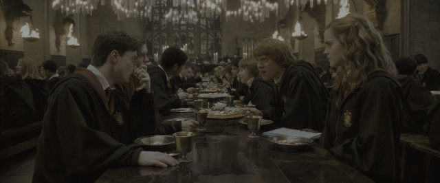 Wide shot frame from Harry Potter and the Half-Blood Prince — sitting, room, table