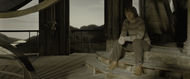 Wide shot frame from Harry Potter and the Half-Blood Prince — sitting, shirt, face