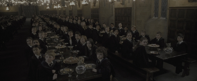 Wide shot frame from Harry Potter and the Half-Blood Prince — sitting, room, table