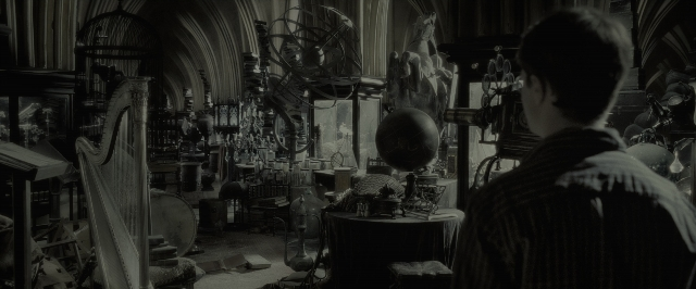 Wide shot frame from Harry Potter and the Half-Blood Prince — standing, room, table