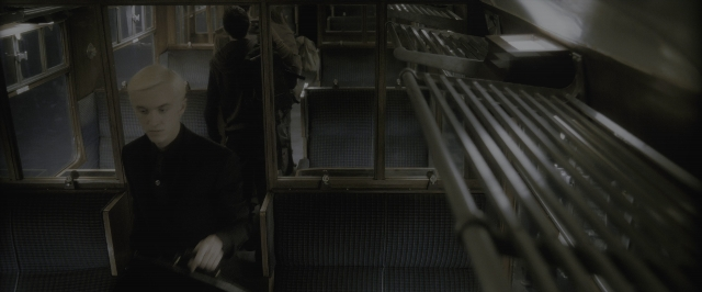 Wide shot frame from Harry Potter and the Half-Blood Prince — sitting, car, face