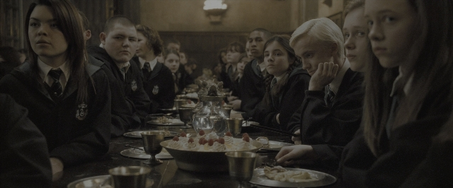 Wide shot frame from Harry Potter and the Half-Blood Prince — sitting, room, table