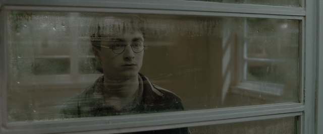 Medium shot frame from Harry Potter and the Half-Blood Prince — room, door, face