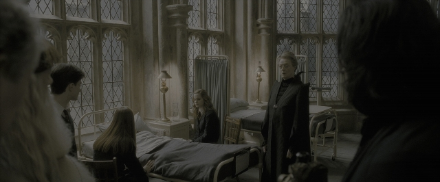 Wide shot frame from Harry Potter and the Half-Blood Prince — sitting, standing, room