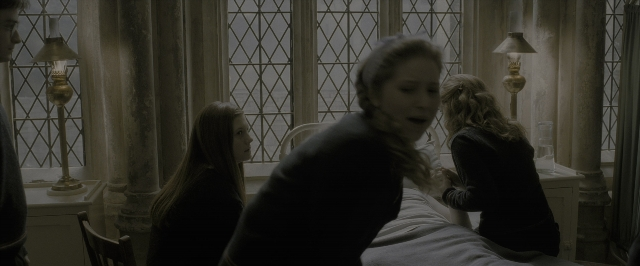 Wide shot frame from Harry Potter and the Half-Blood Prince — sitting, standing, room
