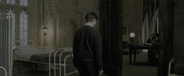 Wide shot frame from Harry Potter and the Half-Blood Prince — standing, room, table