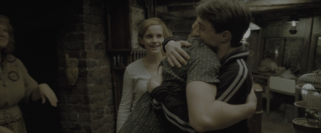Wide shot frame from Harry Potter and the Half-Blood Prince — room, table, face