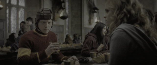 Wide shot frame from Harry Potter and the Half-Blood Prince — sitting, table, hat