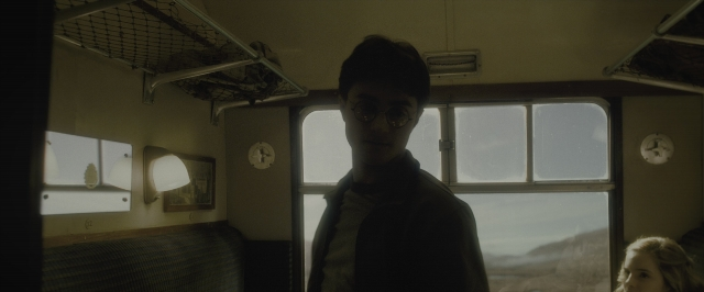 Wide shot frame from Harry Potter and the Half-Blood Prince — standing, car, face