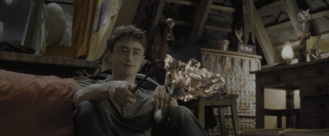 Wide shot frame from Harry Potter and the Half-Blood Prince — sitting, room, hand